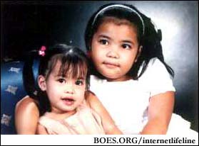 The hard worries are gone. Joie Sampang with her rescued little sister Jerden, October 2002