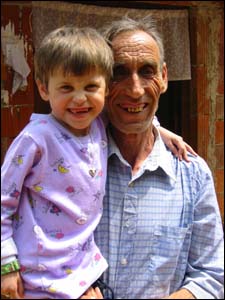 Early July 2002. How they have been missing each other, father and daughter, since she left her family in May, for escort and flight to Montefiore Medical Center in New York. Photo: CIMIC Btl. KFOR, Kosovo